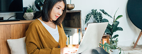 A woman uses her laptop to sign up for MyChart.