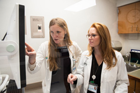 Medical professionals looking at a screen
