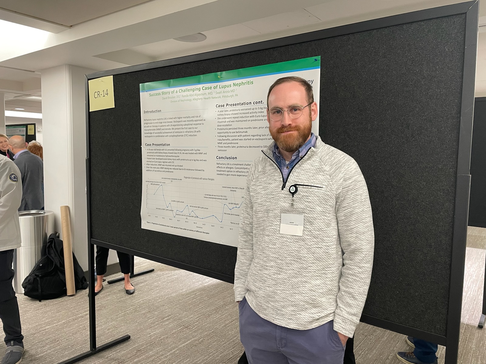 Fellow standing in front of research poster