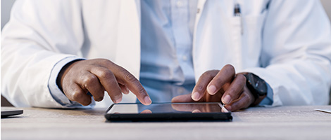 closeup of a set of hands working on a tablet device