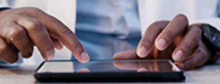 closeup of a set of hands typing on a computer keyboard