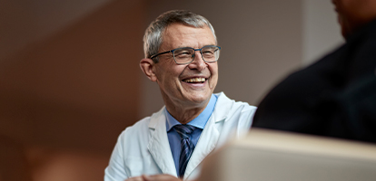 AHN doctor talking to patients about cancer screenings.