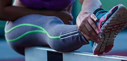 A woman stretching her leg.