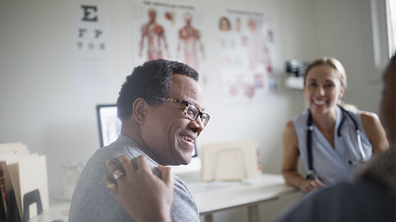 A man smiling as he speaks with AHN specialist.