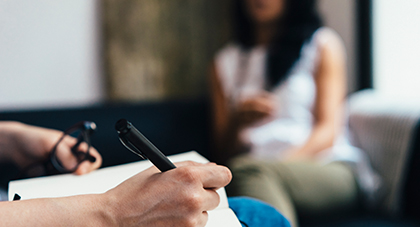 A doctor writing a personalized treatment plan for a patient.