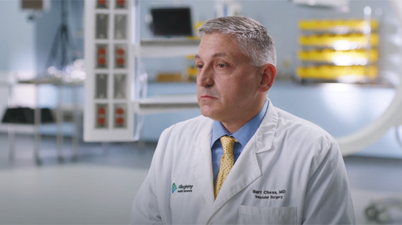 Dr. Bart Chess, a vascular surgeon at AHN Cardiovascular Institute sitting on a chair in a surgery suite. 