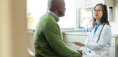 Female doctor talking to a male patient
