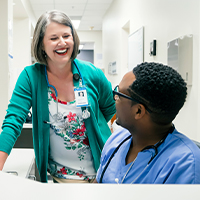 image of a nurse talking to her colleague