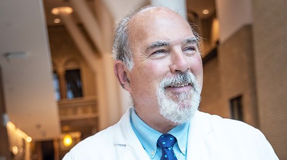 Doctor in office mask talking about epilepsy