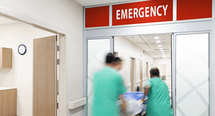 Emergency medical services staff rushing a patient to the ER.