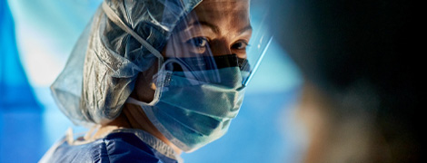 AHN surgeon wearing full facemask and shield while in surgery.